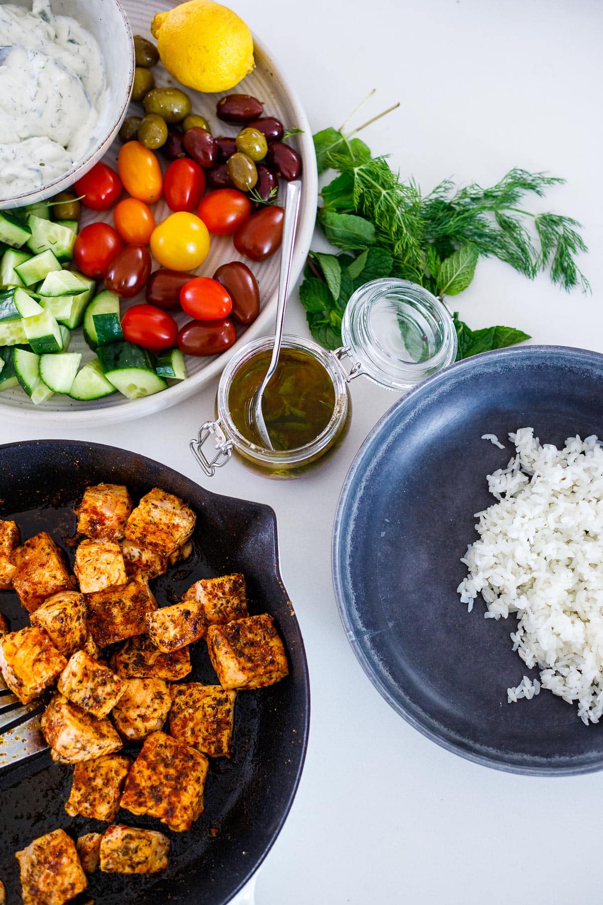 Assembling the greek salmon bowls.