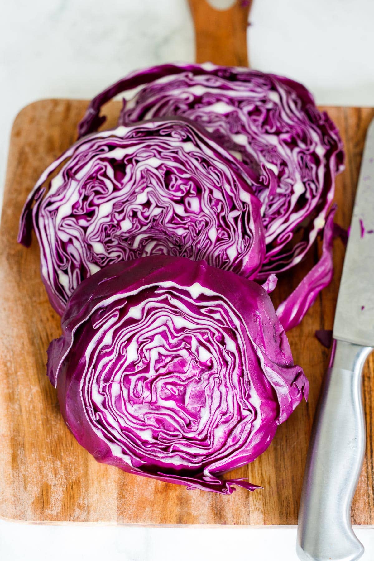 Cabbage slices on a cutting board.