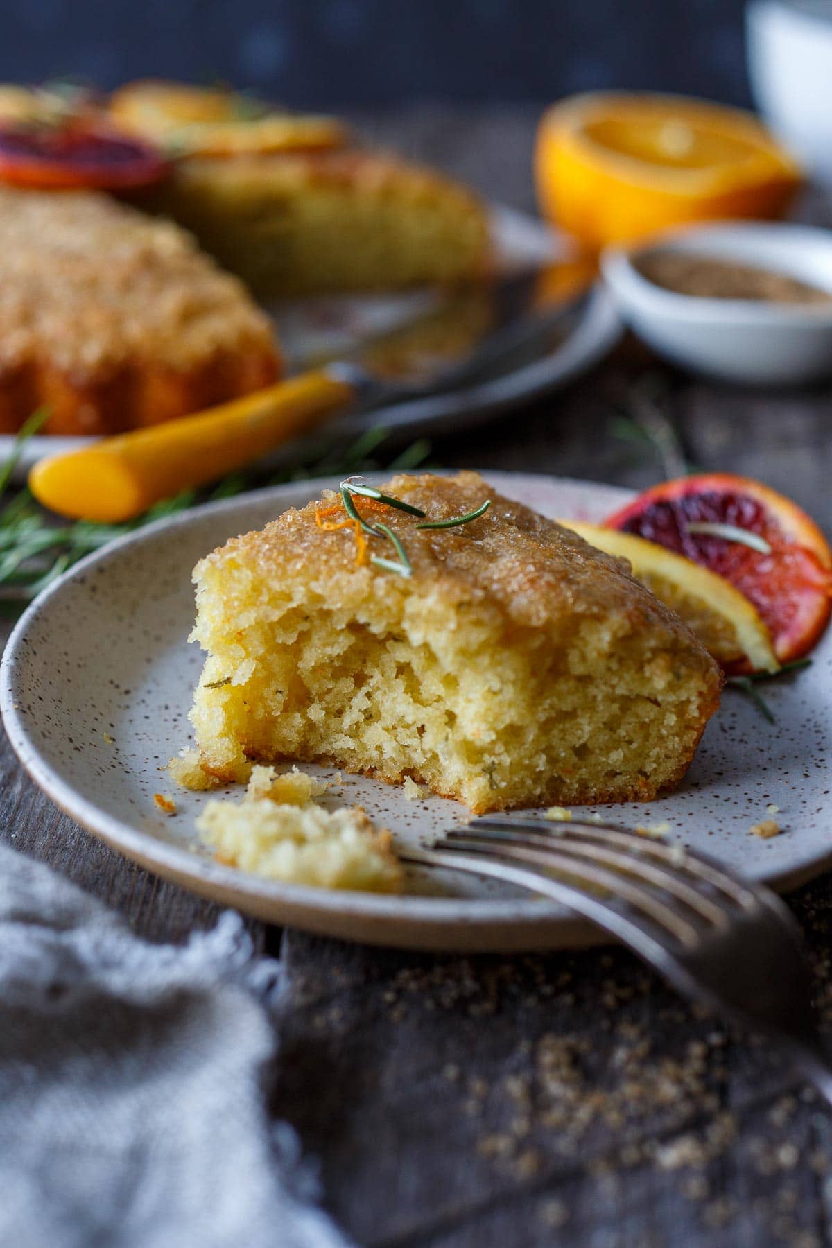 Enhanced with fresh rosemary and orange zest this Olive Oil Cake is easy to make, has a lovely  rustic texture and stays moist for days. Lightly sweetened, it is perfect for dessert, brunch or with afternoon tea.