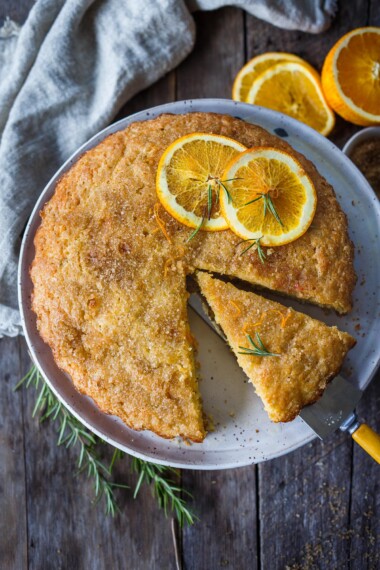 Enhanced with fresh rosemary and orange zest this Olive Oil Cake is easy to make, has a lovely rustic texture and stays moist for days. Lightly sweetened, it is perfect for dessert, brunch or with afternoon tea.