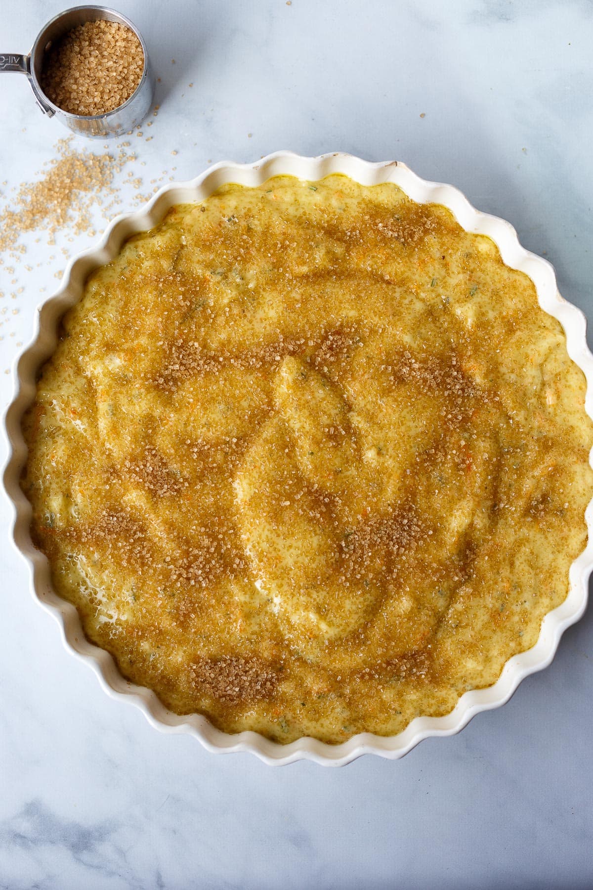 Cake in a baking pan sprinkled with coarse sugar.