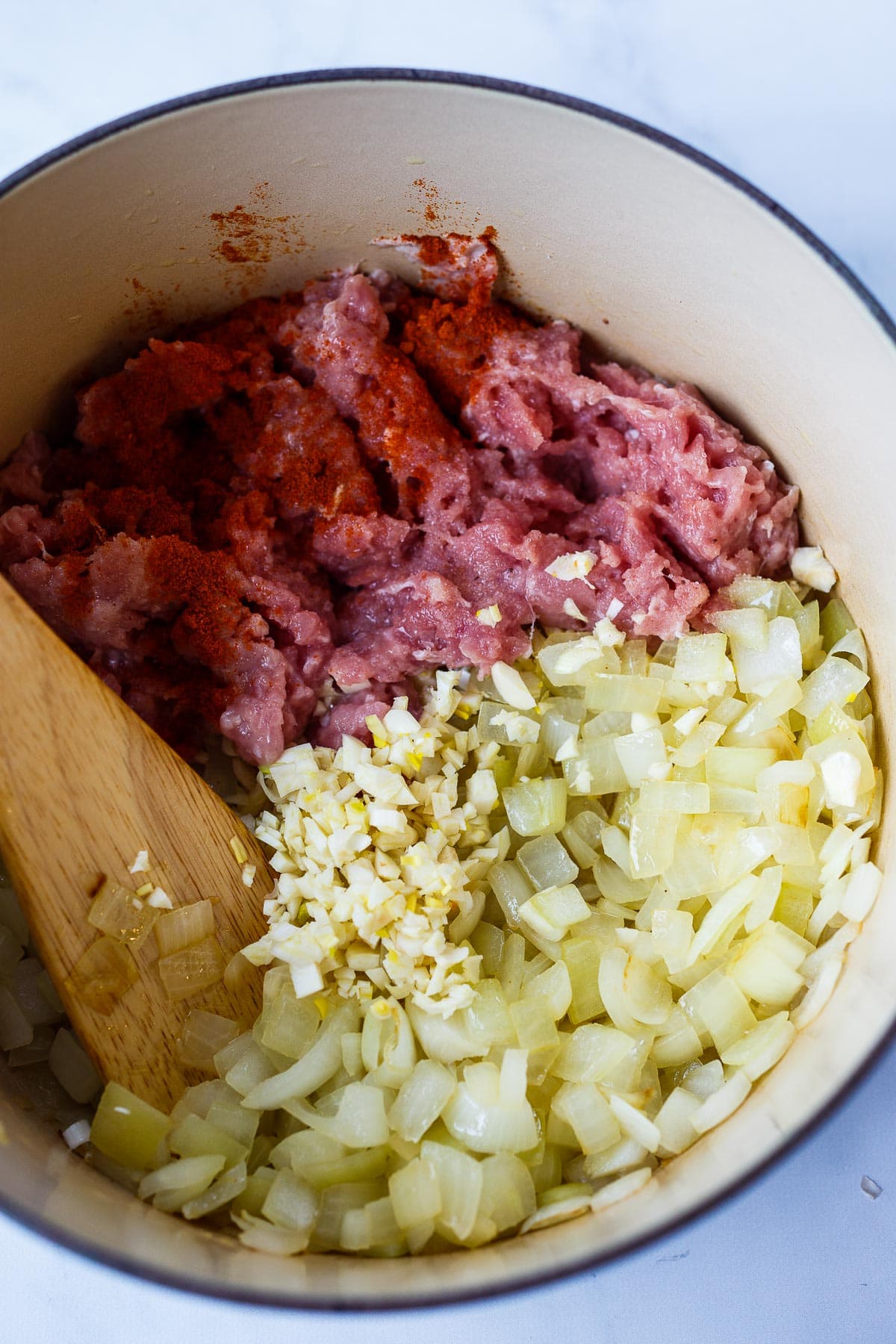 Sauteed onions, garlic and ground turkey in a pot.