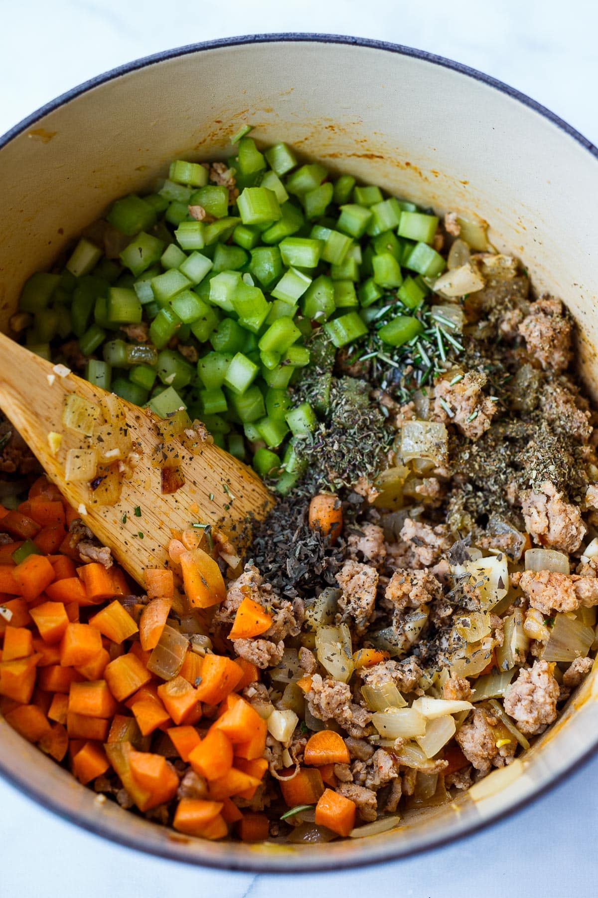 Sauteed vegetables and meat in a pot.