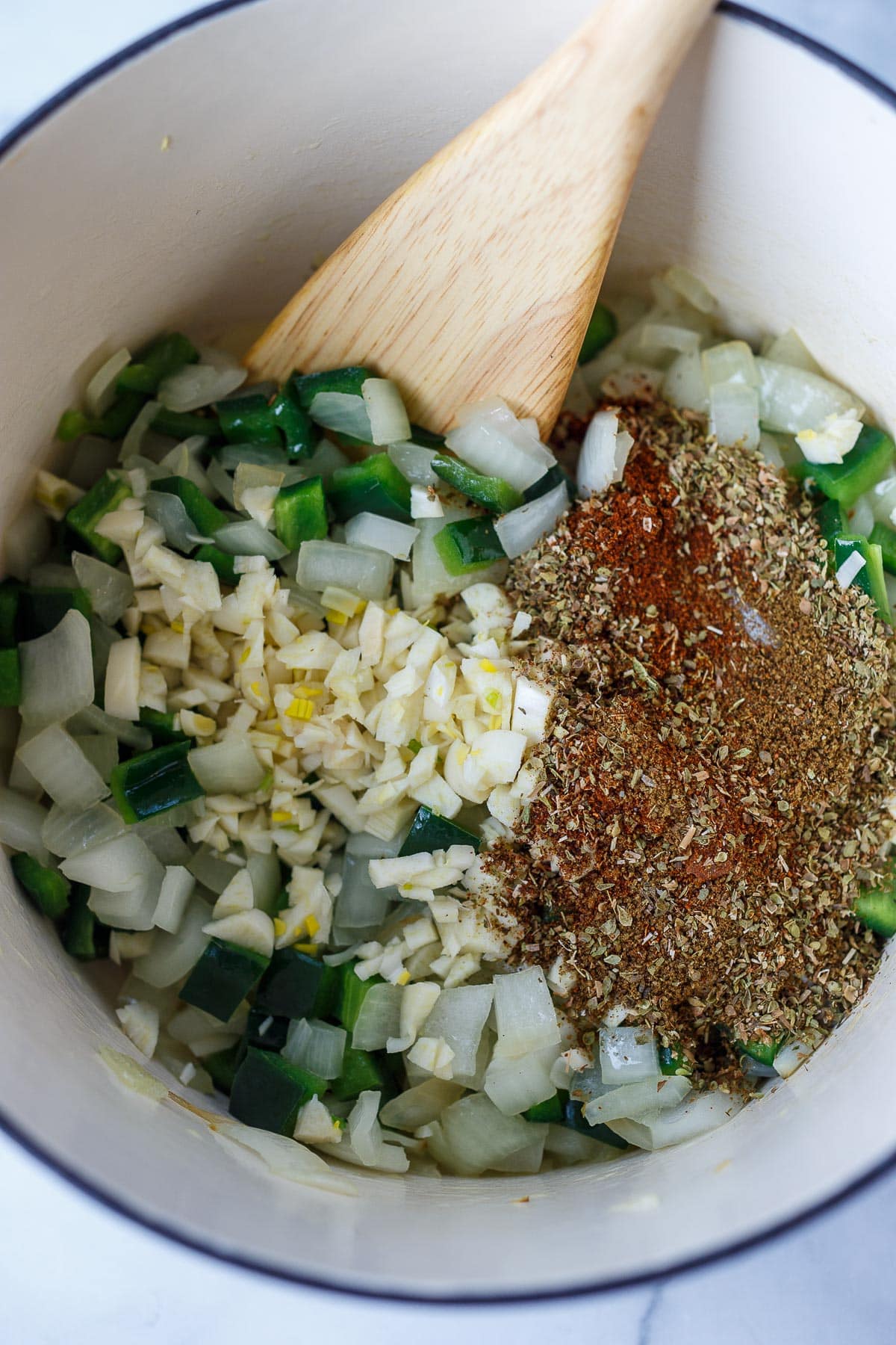 Onions, garlic, peppers and spices cooking in the pot.