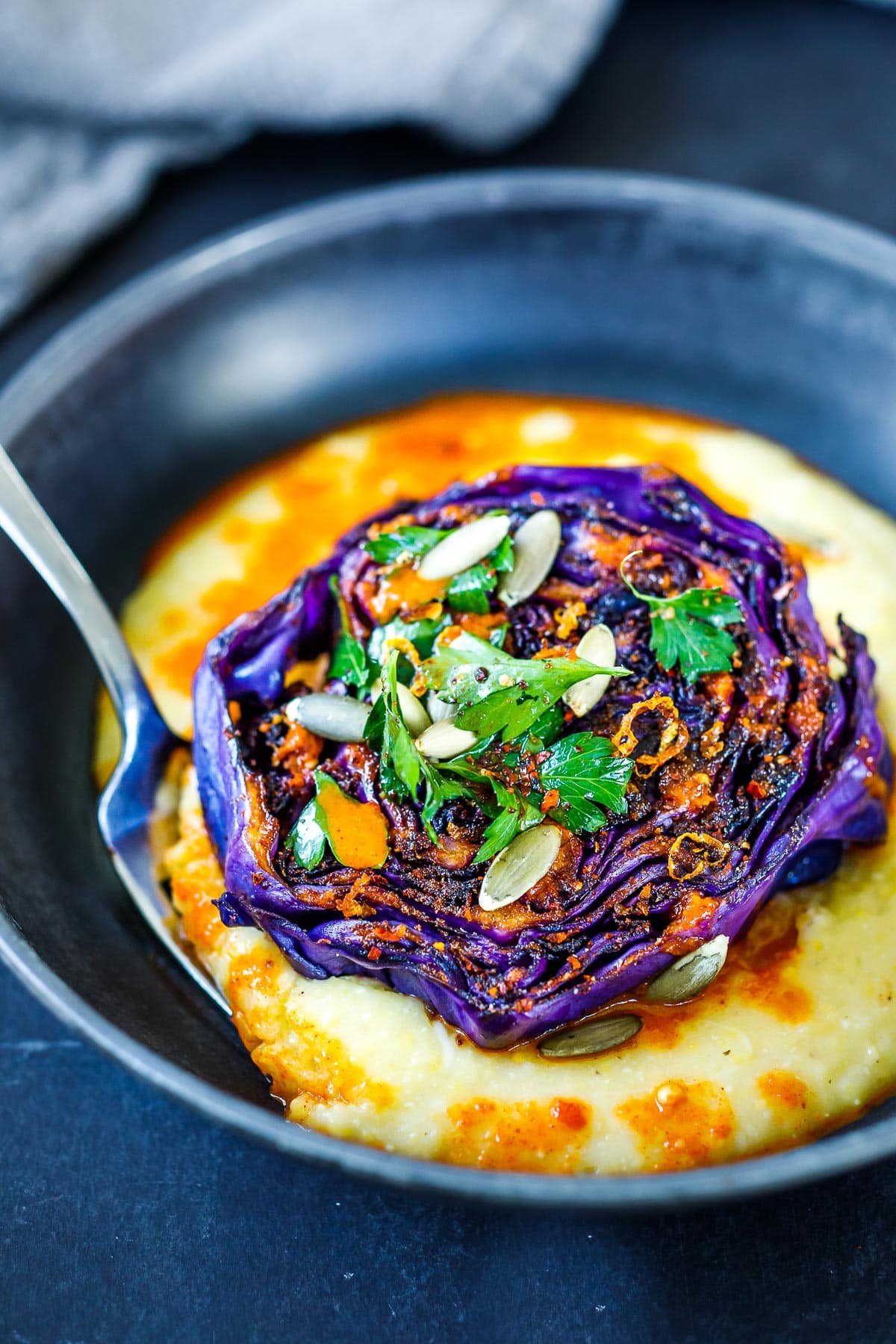 Cabbage steaks with polenta and pickled pepper vinaigrette. 