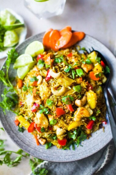 This Pineapple Fried Rice holds all the Thai flavors of spicy, sweet, and salty with a perfect tang from the pineapple and tops off with a crunchy nutty taste of cashew. It is a delicious Thai dish that is fast to put together. Vegan adaptable!