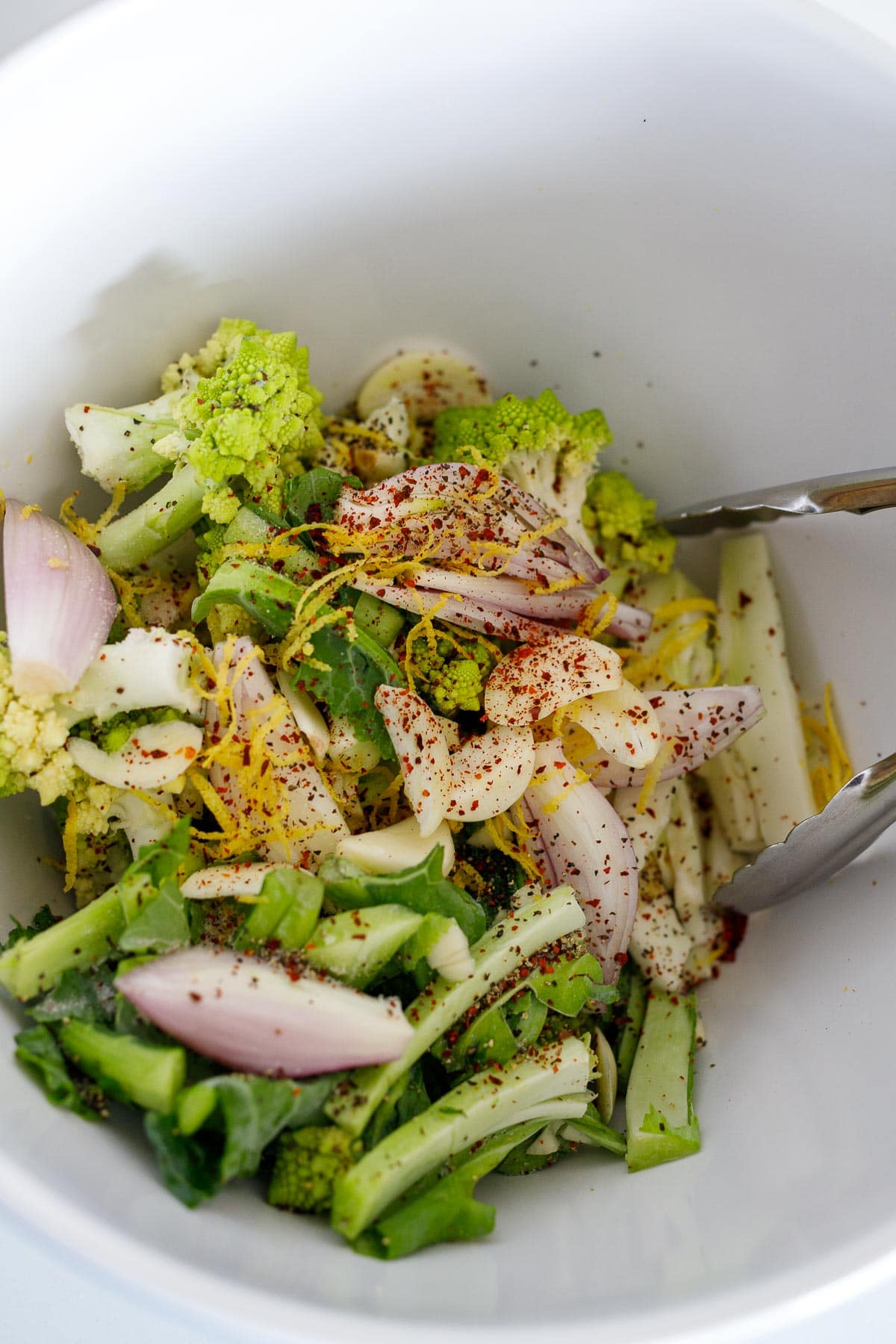 Seasoning romanseco in a bowl. 