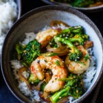 Shrimp Stir Fry with broccoli florets in a flavorful, fresh orange ginger sauce. Healthy and easy, this dish will be on your dinner table in under 30 minutes!