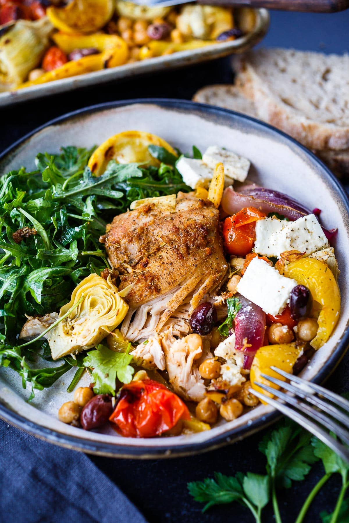 Mediterranean Chicken with veggies, chickpeas, olives  and herbs. A delicious Sheet Pan Dinner. 