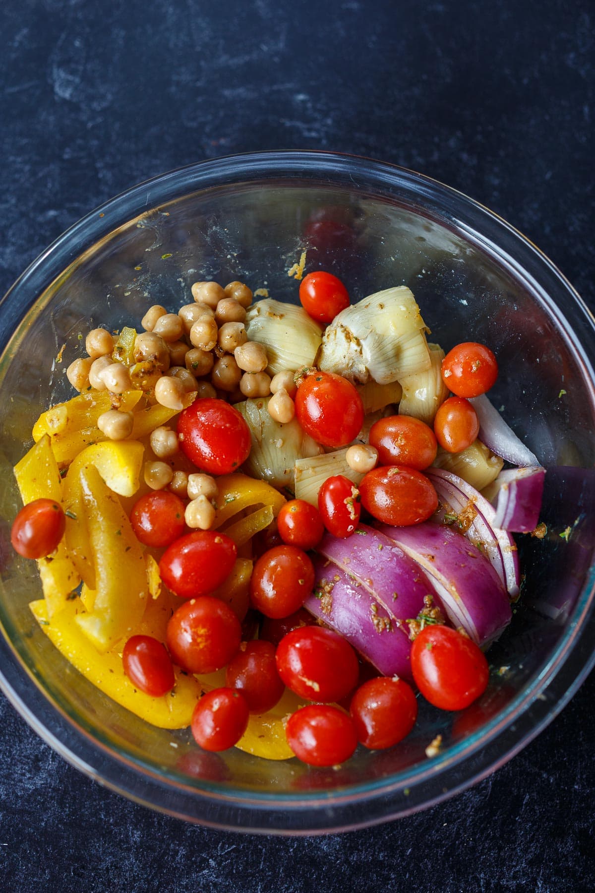 Mixing vegetables with the marinade.