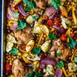Mediterranean Chicken with veggies, chickpeas, olives and herbs. A delicious sheet pan dinner that is easy to make and easy to clean up! 