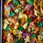 Mediterranean Chicken with veggies, chickpeas, olives and herbs. A delicious sheet pan dinner that is easy to make and easy to clean up!
