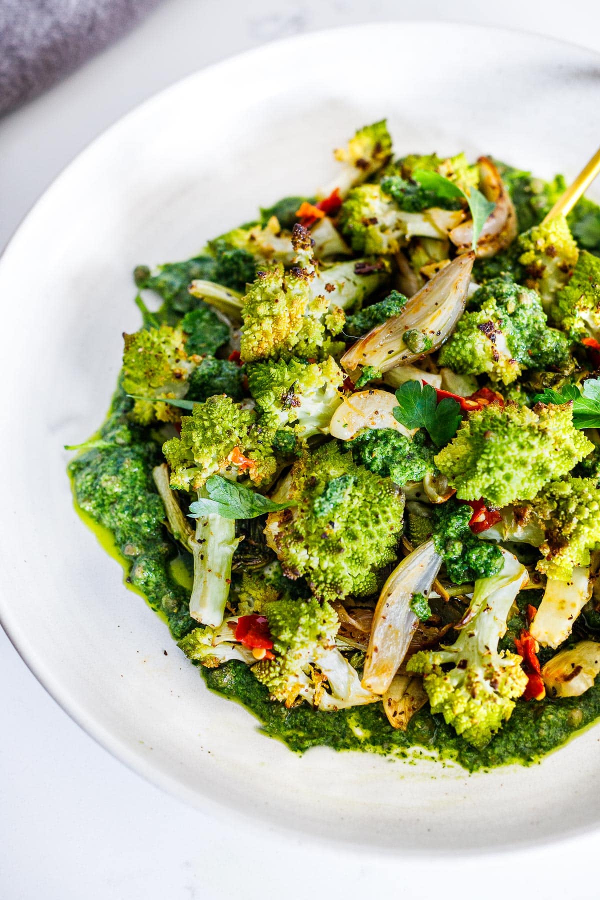 How to cook Romanesco- broccoli and cauliflower's Italian cousin. Her we've roasted with garlic, shallots, & lemon, and served it with Italian Salsa Verde & Calabrian chilies. 