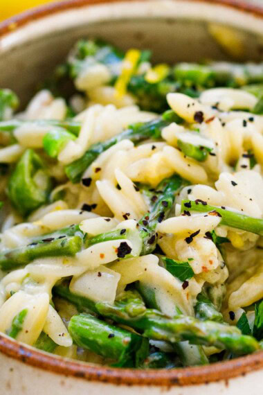 This recipe for Asparagus Orzo is perfect for spring! Quick and easy, this vegetarian dinner can be made in 30-minutes! Enjoy it as a side dish or see notes on how to serve it chilled as a salad.