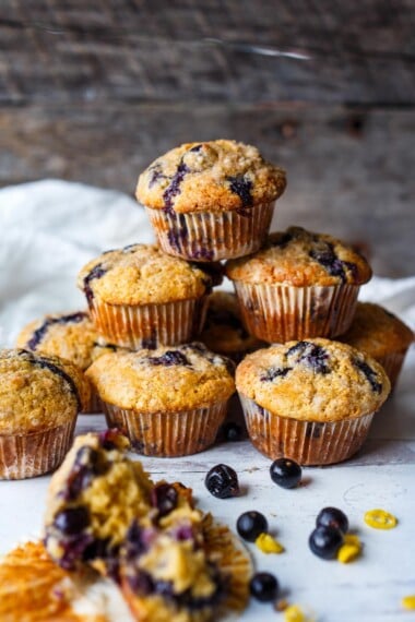Tender Blueberry Muffins lightly sweetened, enhanced with lemon zest, vanilla and cardamom made with fresh or frozen blueberries. A delicious breakfast or afternoon snack. Gluten-free adaptable.