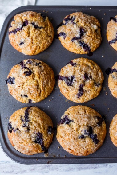 Tender Blueberry Muffins lightly sweetened, enhanced with lemon zest, vanilla and cardamom made with fresh or frozen blueberries. A delicious breakfast or afternoon snack. Gluten-free adaptable.