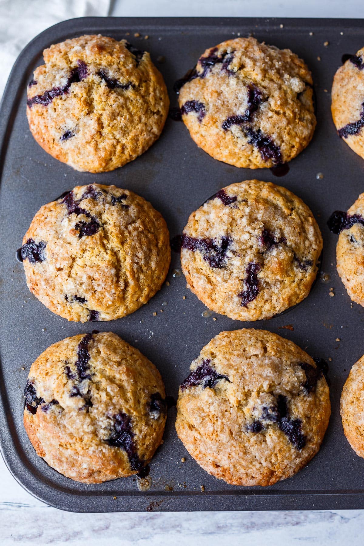 Tender Blueberry Muffins lightly sweetened with lemon zest and cardamom made with fresh or frozen blueberries. A delicious breakfast or afternoon snack. Gluten free adaptable.