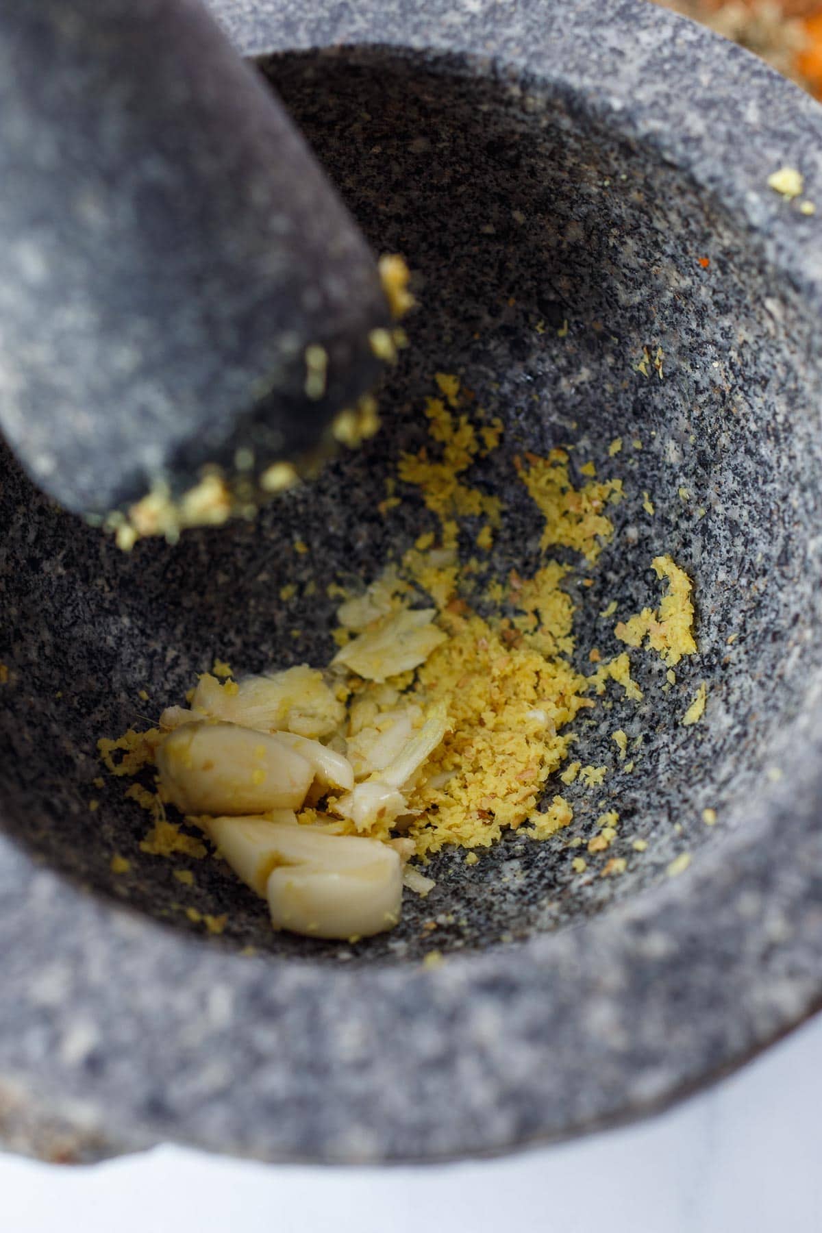 Garlic and ginger in mortar and pestle.