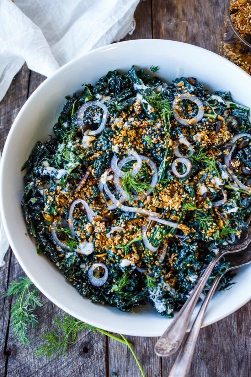 Full of healthy texture and flavor, this nutrient-dense Kale Salad with creamy buttermilk dressing and tamed red onions is sprinkled with an addicting crunchy salad topper.