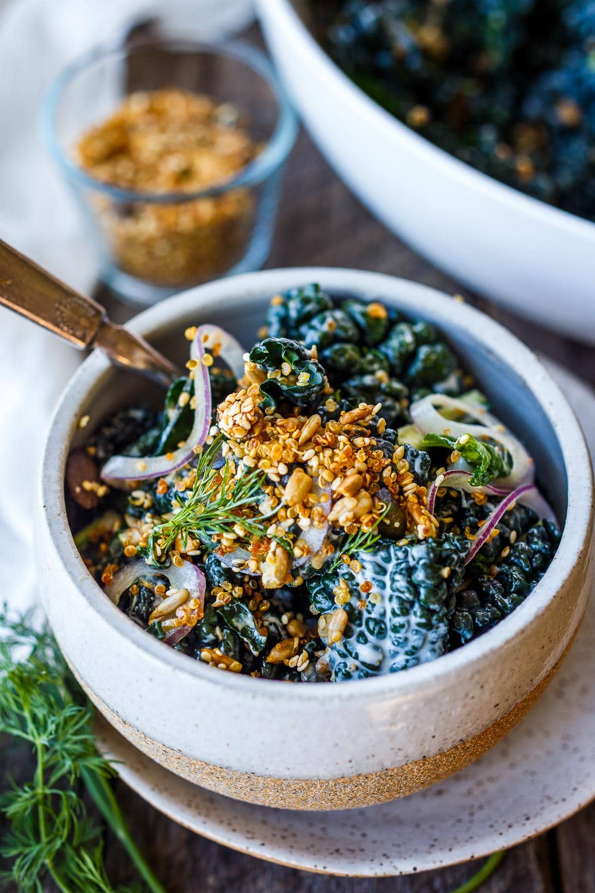 Full of healthy texture and flavor, this nutrient-dense Kale Salad is enhanced with creamy buttermilk dressing, tamed red onions and topped with an addicting crunchy quinoa salad topper.
