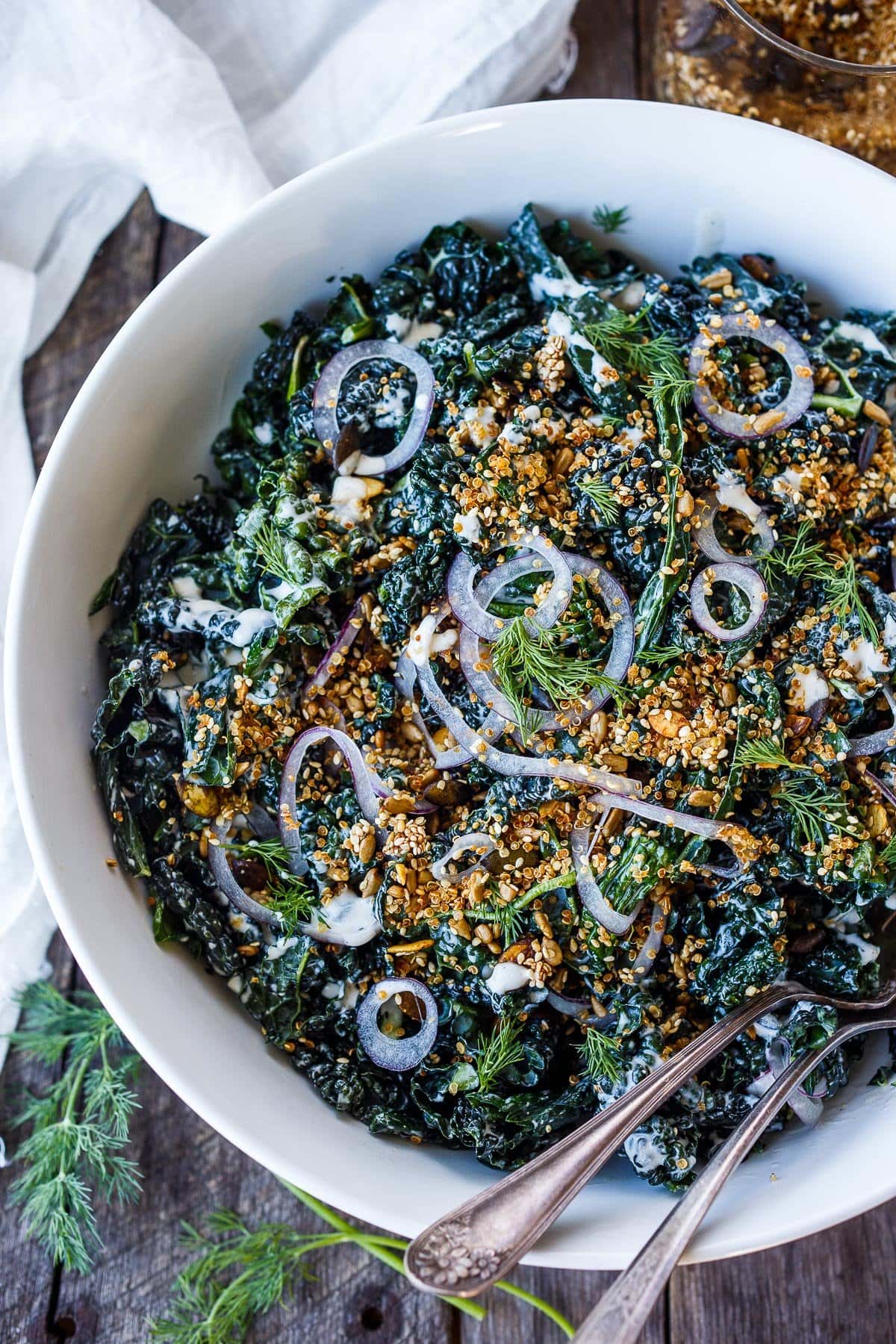 Full of healthy texture and flavor, this nutrient-dense Kale Salad with creamy buttermilk dressing and tamed red onions is sprinkled with an addicting crunchy salad topper.