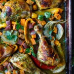 A delicious recipe for Cuban Mojo Chicken. Thighs and legs roasted in the oven with a citrusy mojo marinade alongside yams and peppers. An easy sheet pan dinner!