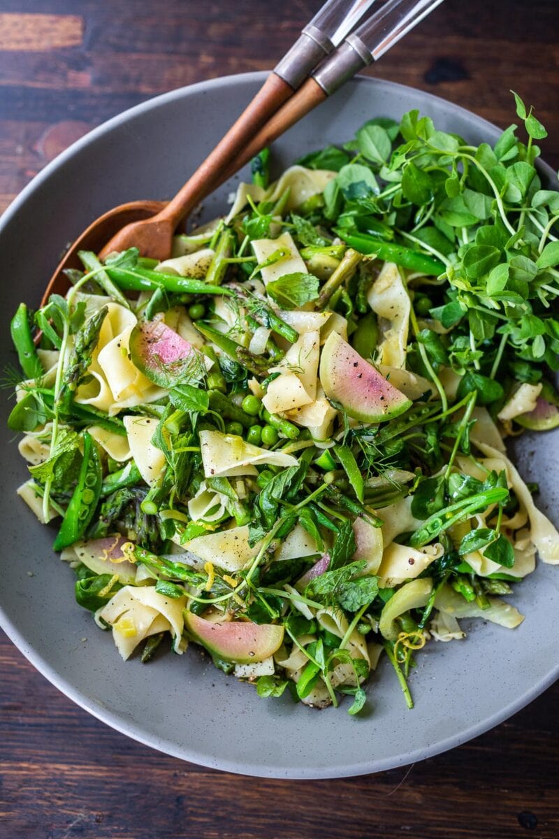 Pasta Primavera or "Spring Pasta" highlights tender spring vegetables-asparagus, peas, leeks and pea shoots, tossed with pappardelle, lemon zest, olive oil and spring herbs.