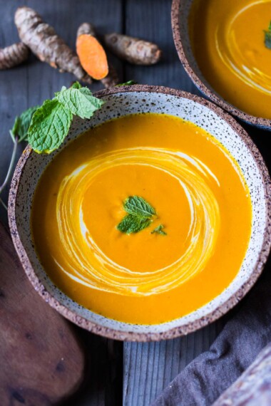 A simple recipe for Glowing Carrot Ginger Soup with turmeric and  Coconut Milk is light, luscious, earthy and flavorful. Fresh turmeric root gives it a hint of the exotic.