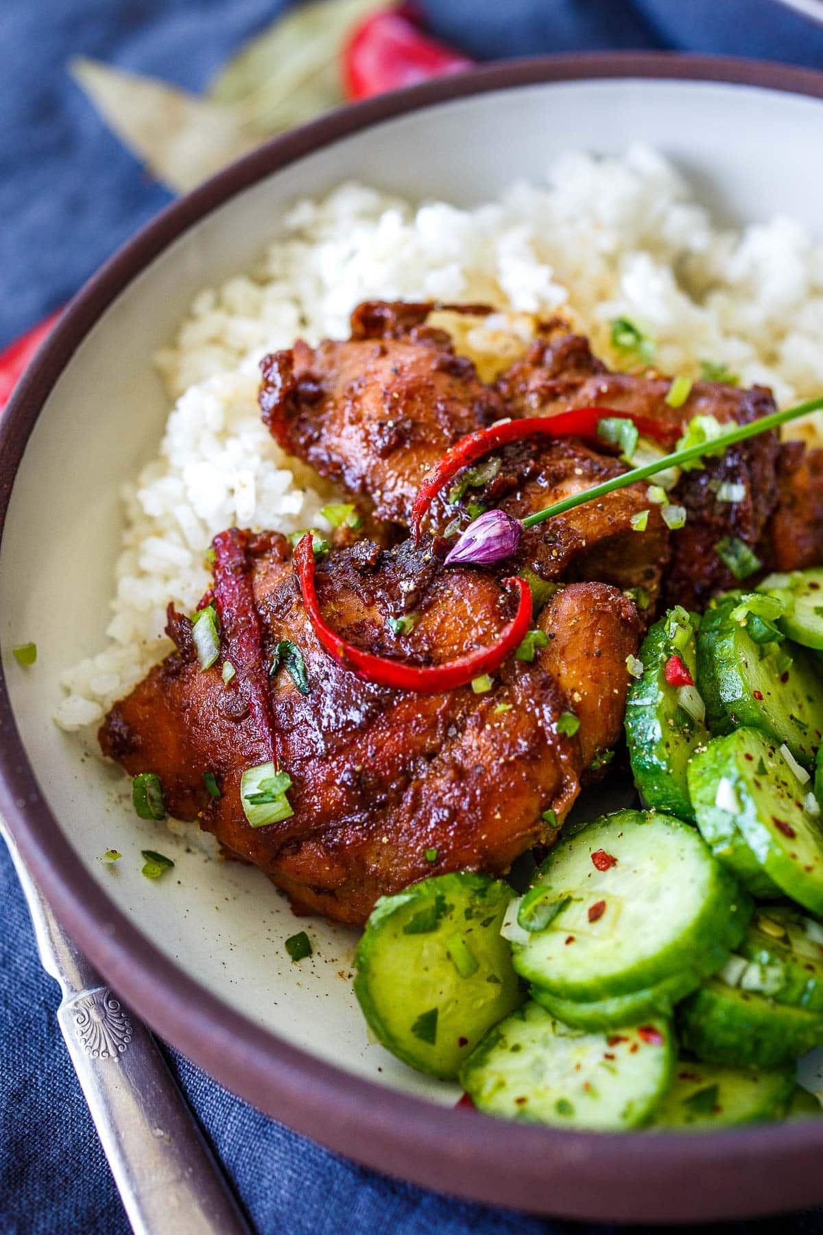 Chicken Adobo served with jasmine rice and Asian cucumber salad.