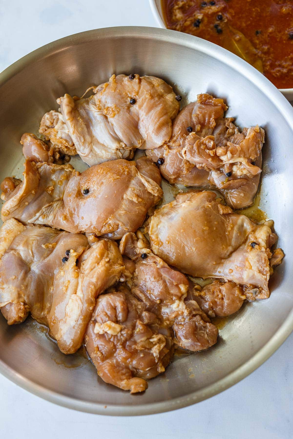 Chicken thighs in a pan.