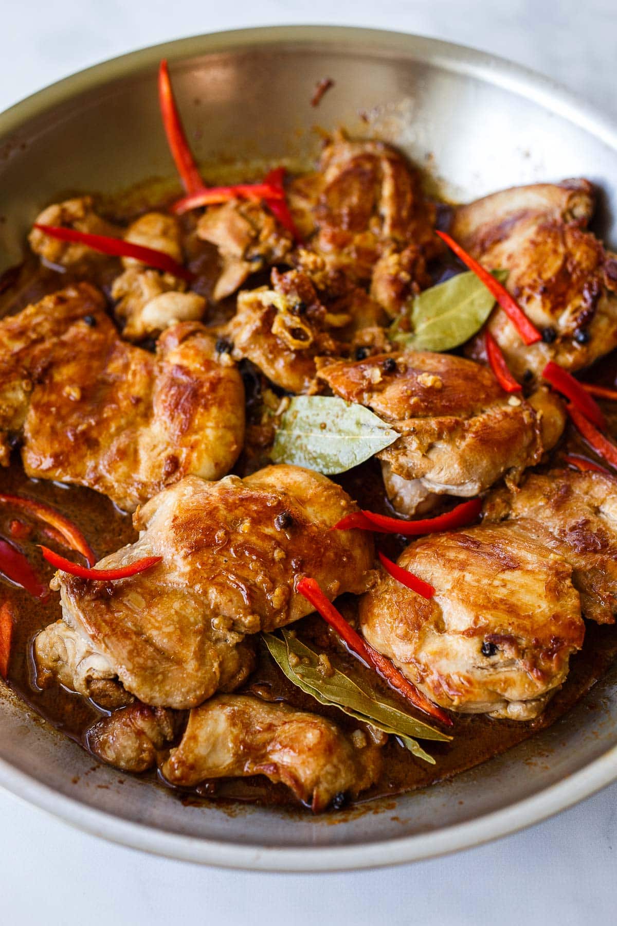 Chicken simmering in marinade.