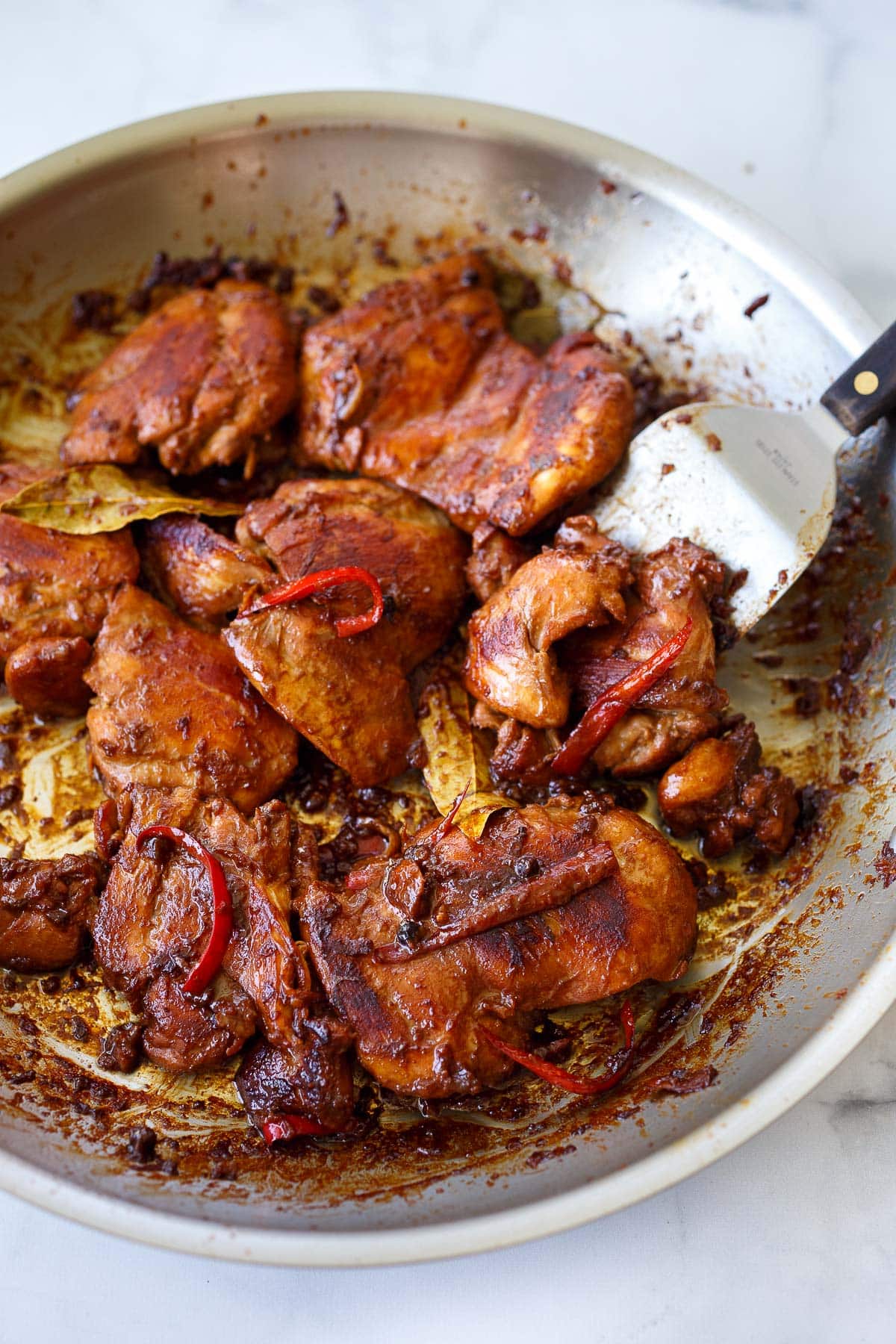 Chicken adobo cooked in a pan.