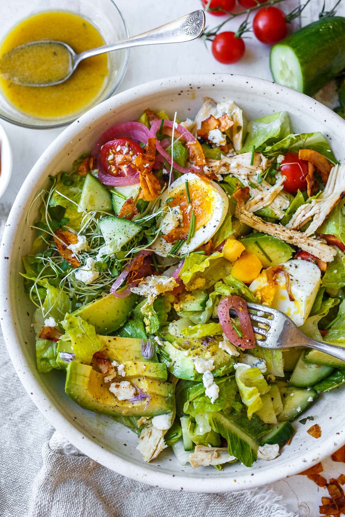 Cobb salad in a bowl with a fork. 