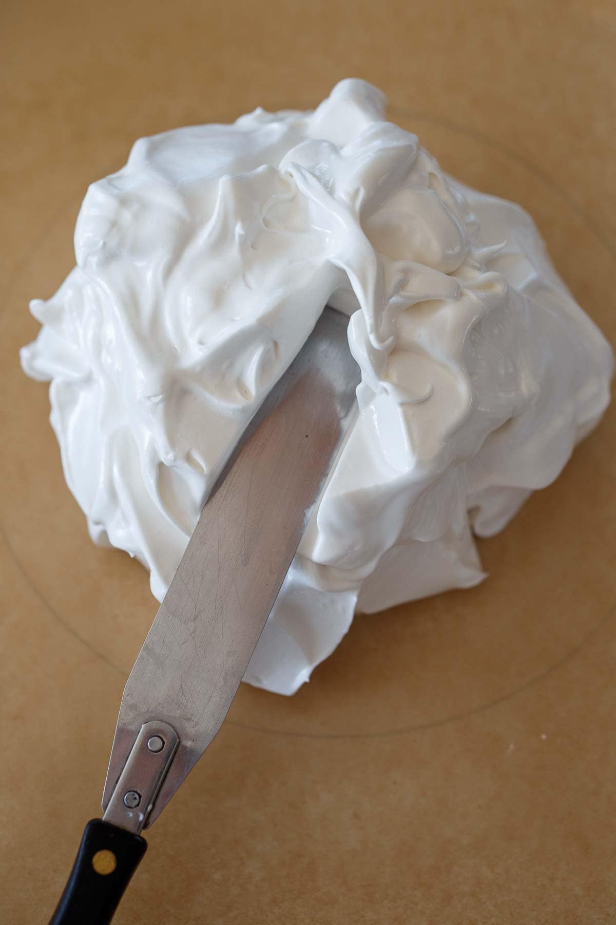 Spreading out the pavlova.