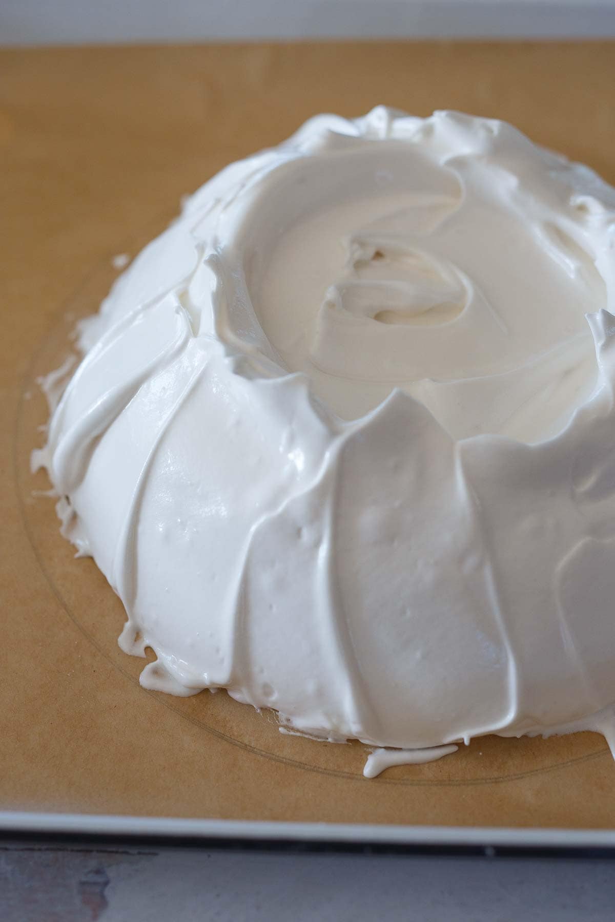 Smoothing up the sides of the pavlova.
