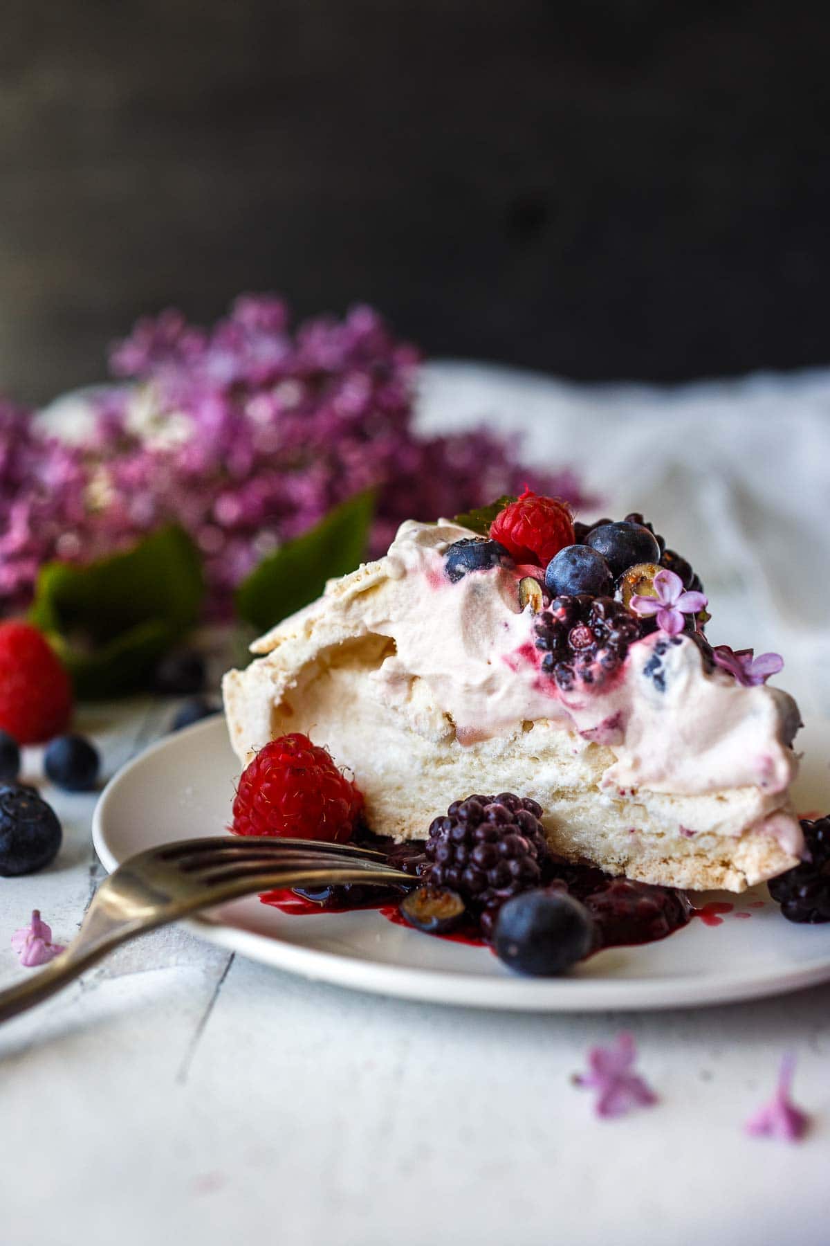 Pavlova with fresh berries and lofty whip cream. A light and airy dessert!