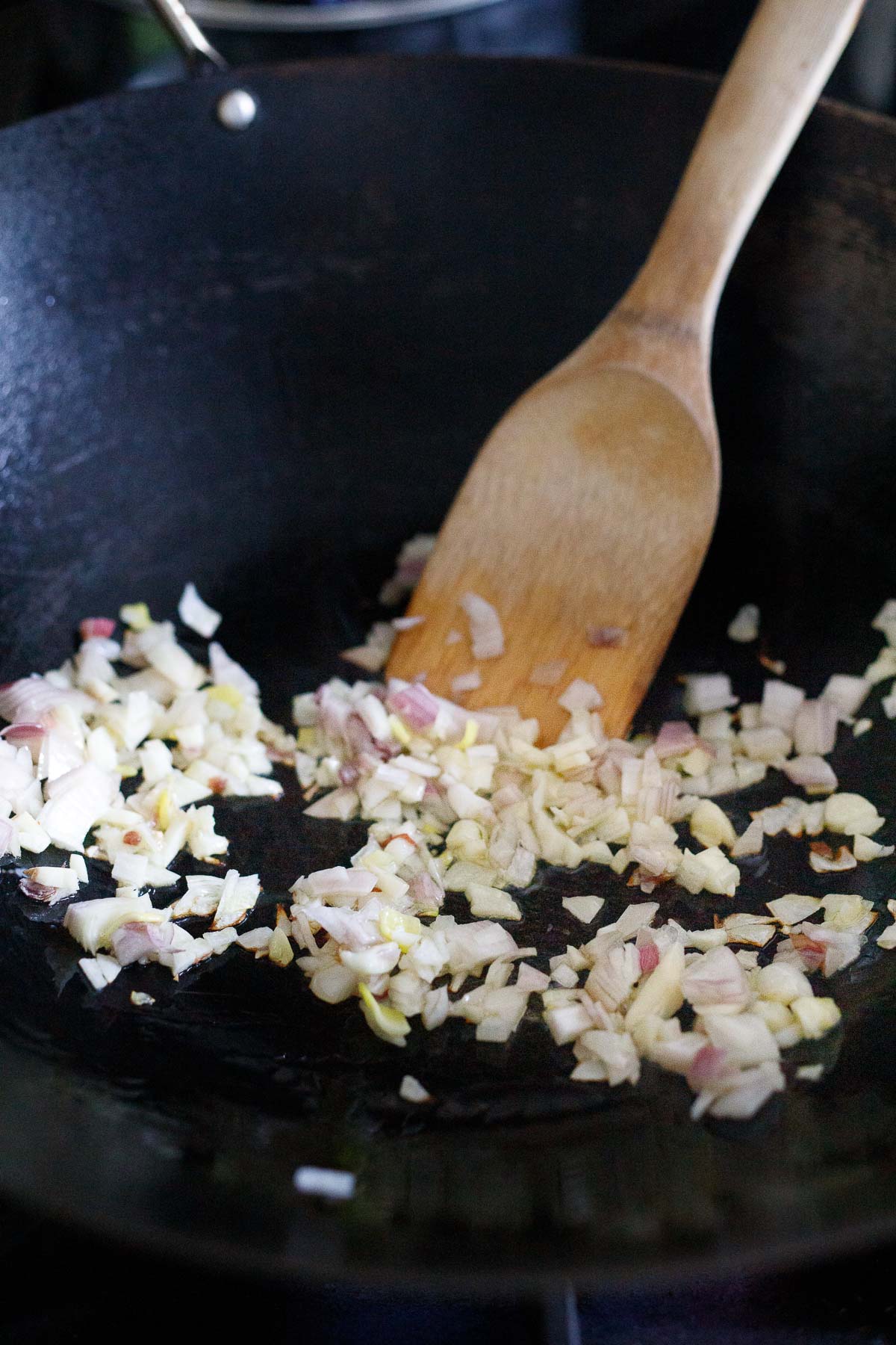 stir frying  garlic and onion in a wok. 