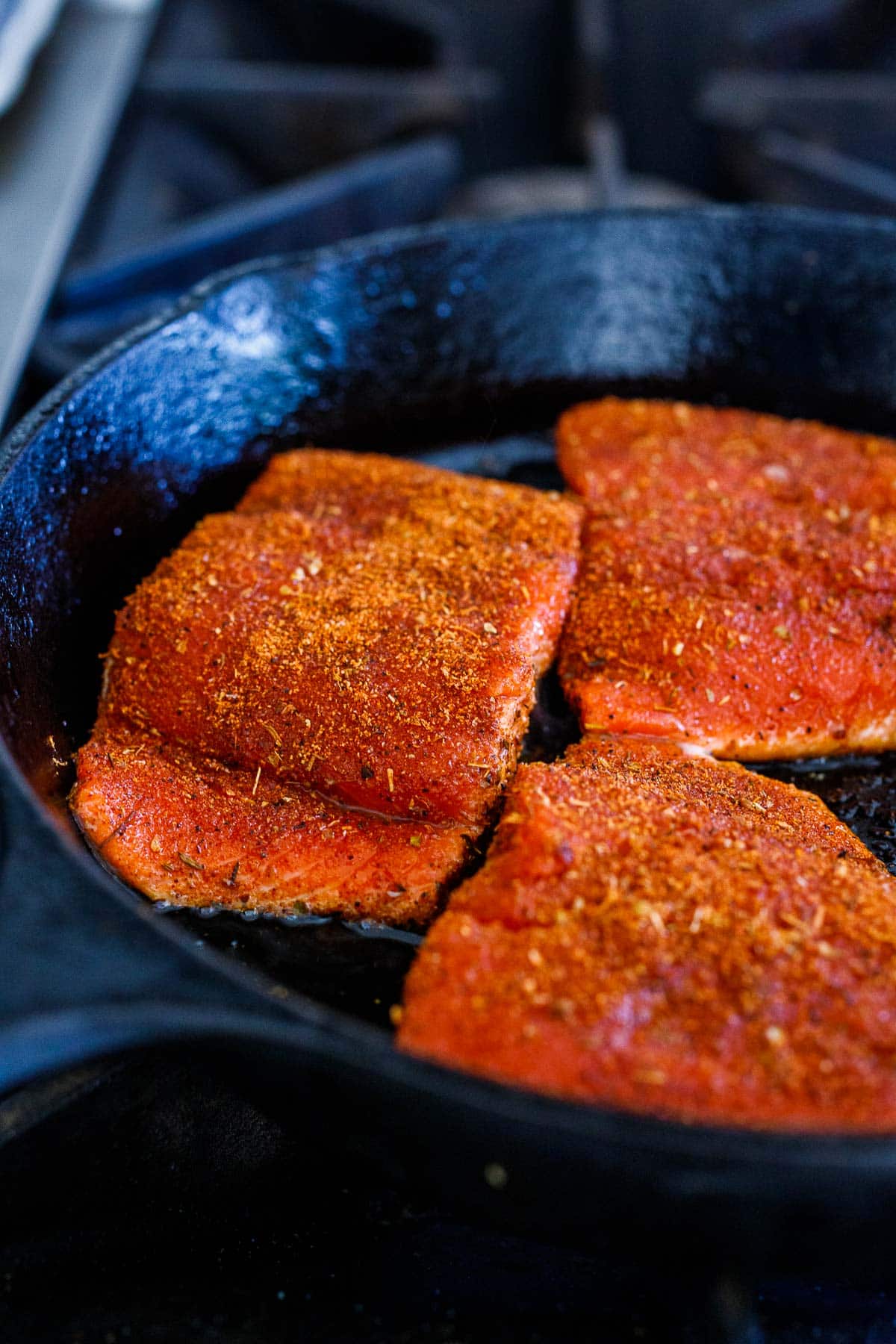 Searing the salmon in a skillet. 