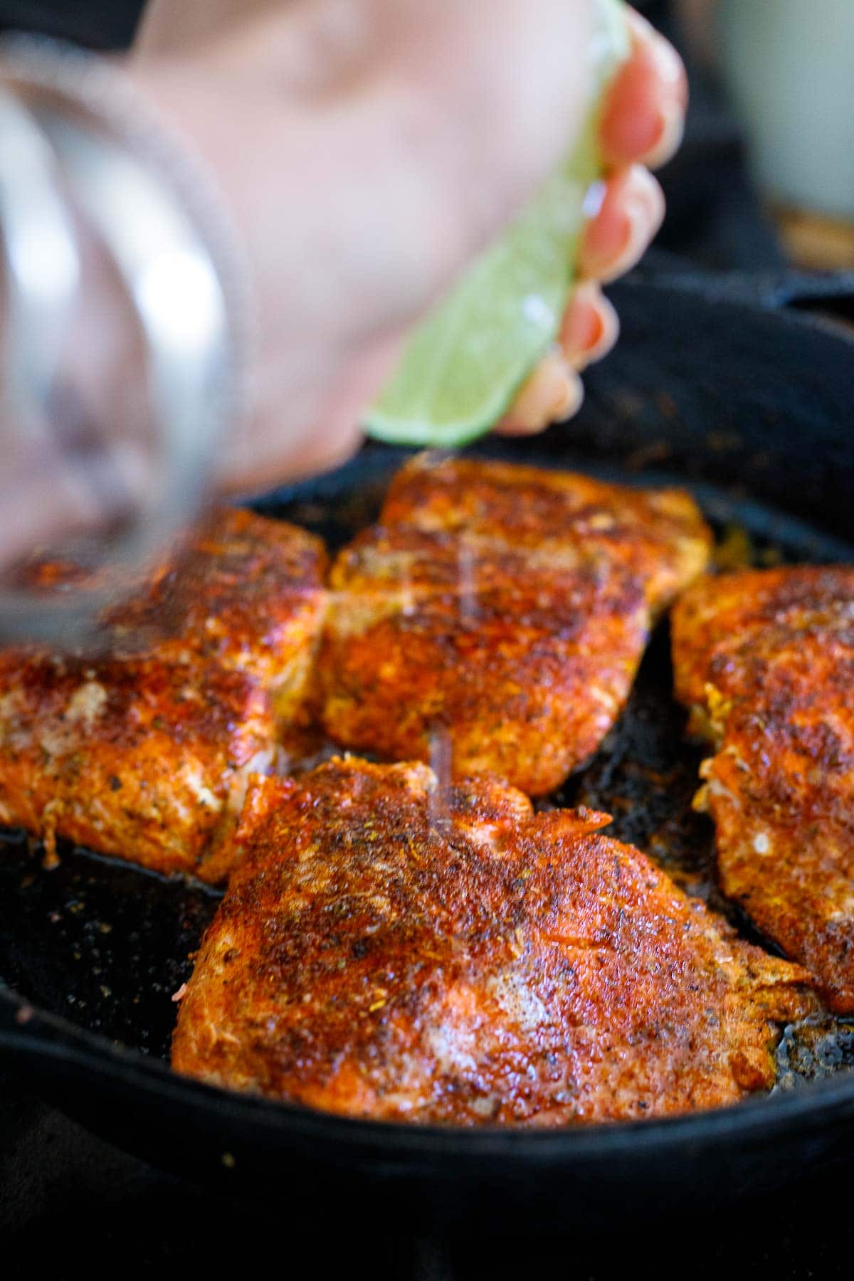 squeezing lime over salmon.