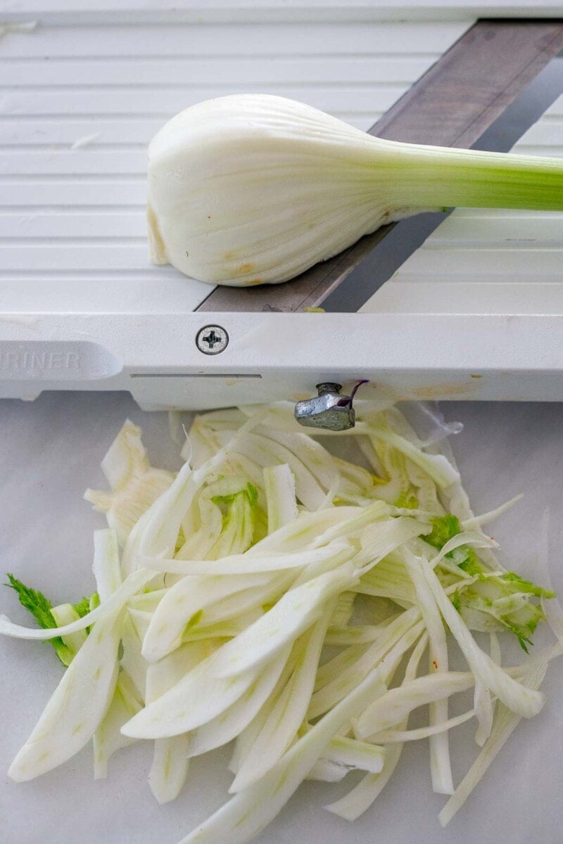 Slicing fennel on a mandolin.