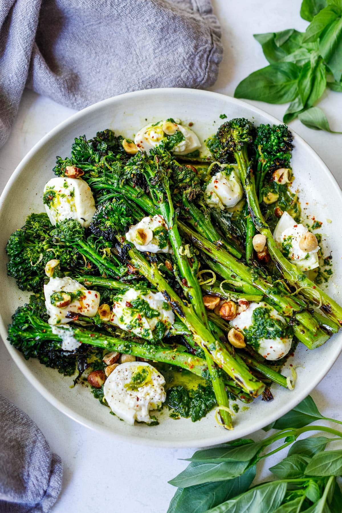 Grilled Broccolini with burrata cheese, toasted hazelnuts and basil oil- a tasty summer side dish perfect for outdoor dinners and gatherings.
