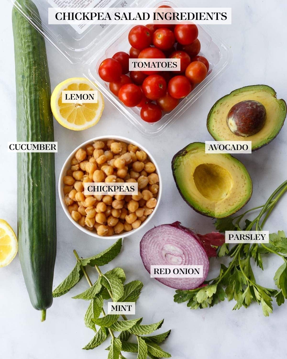 Ingredients in Chickpea Salad on a white counter.