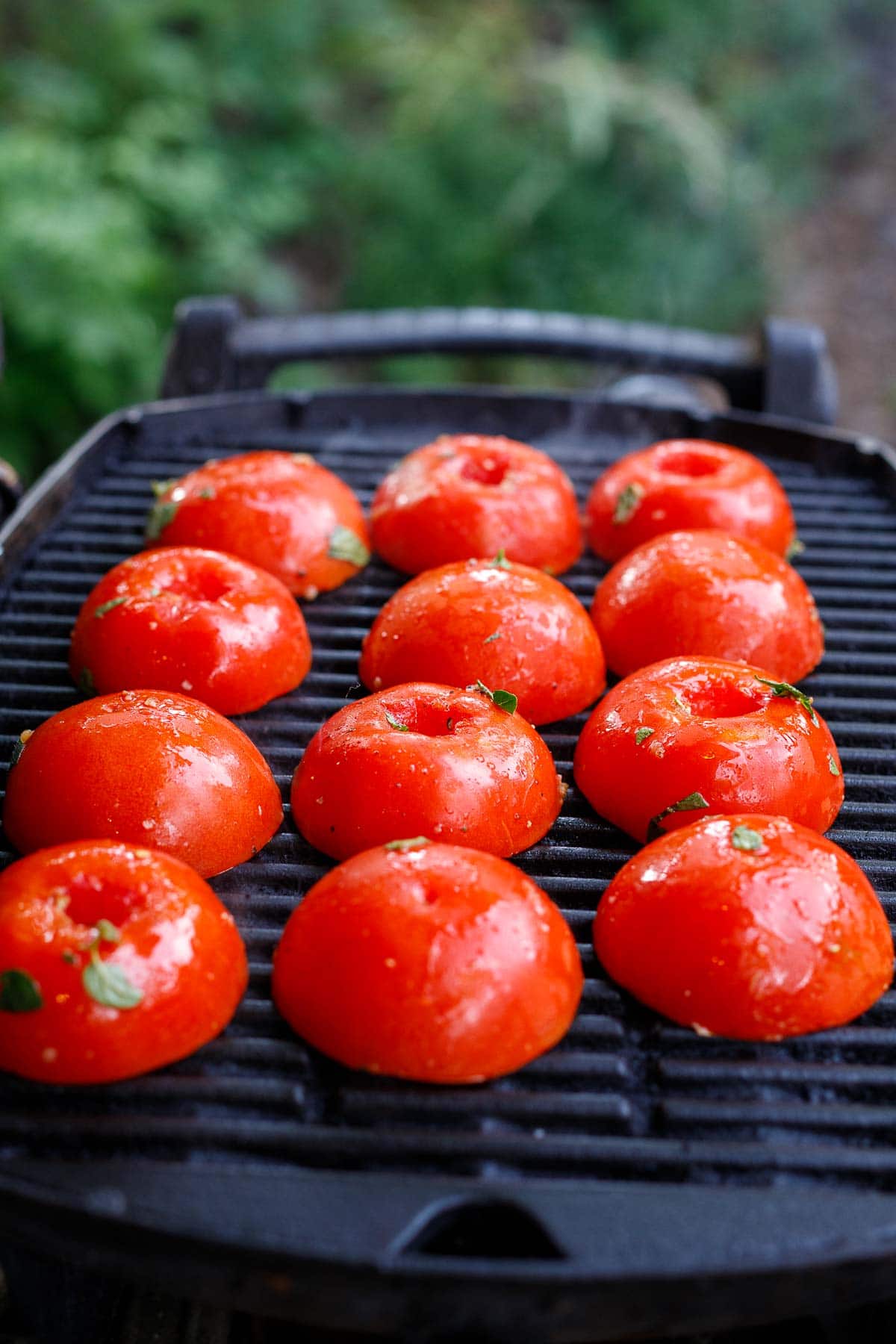 Grilling the tomatoes, open side down. 
