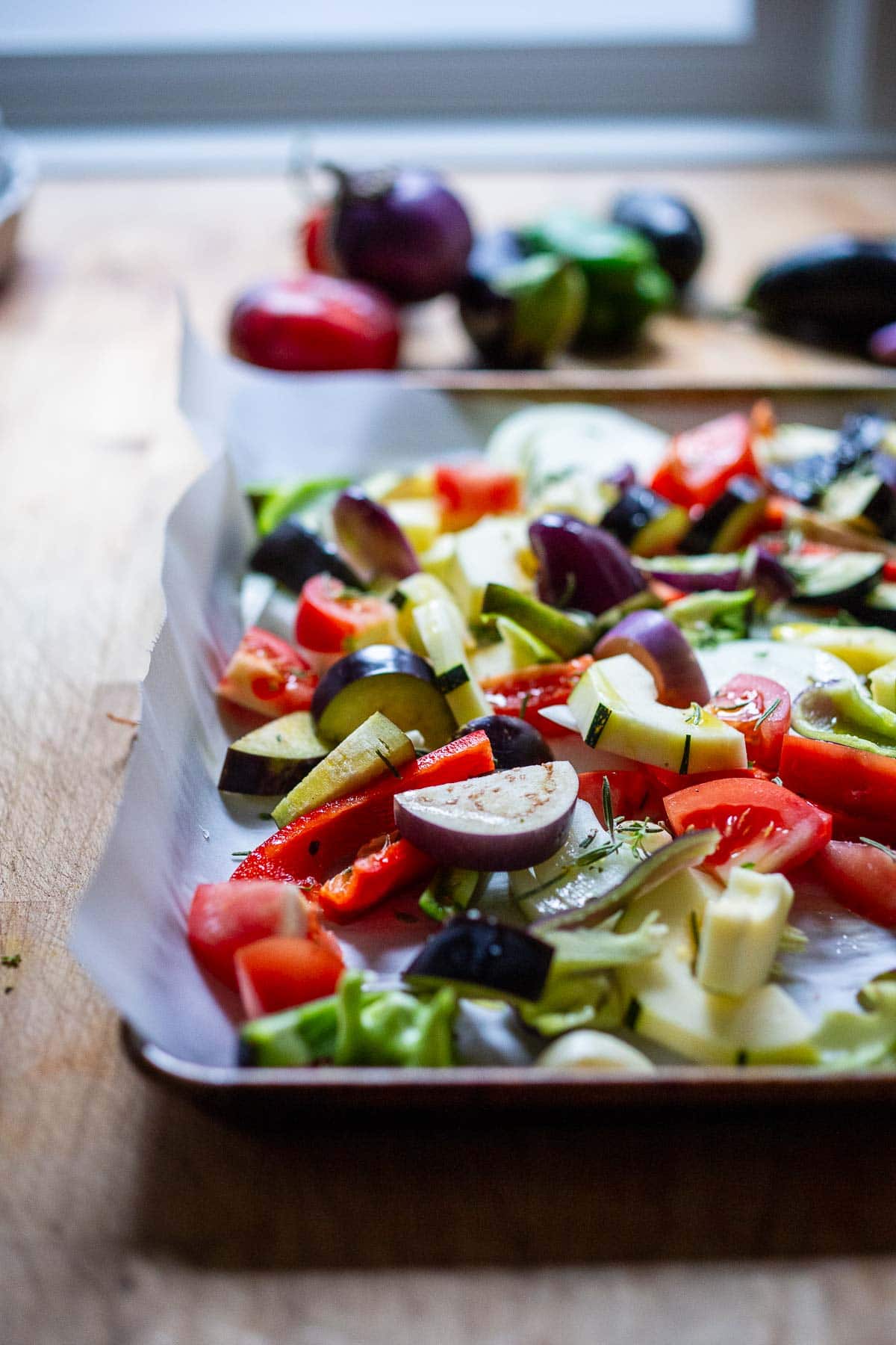 prepping the ratatouille ingredients on a sheet pan.