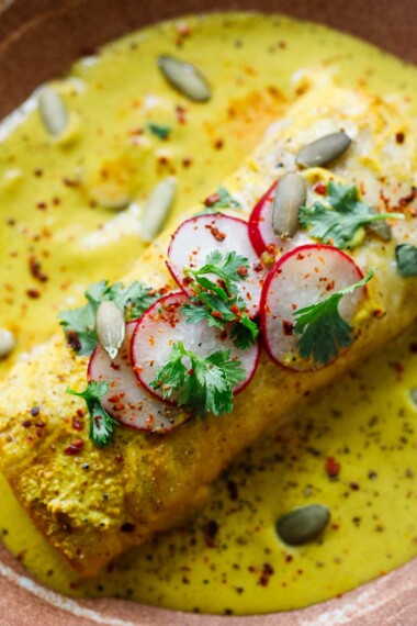 A delicious recipe for Shrimp Enchiladas, filled with tender garlic shrimp, sweet corn, and lime zest, lathered in a flavorful Yellow Mole Sauce. Vegetarian-adaptable
