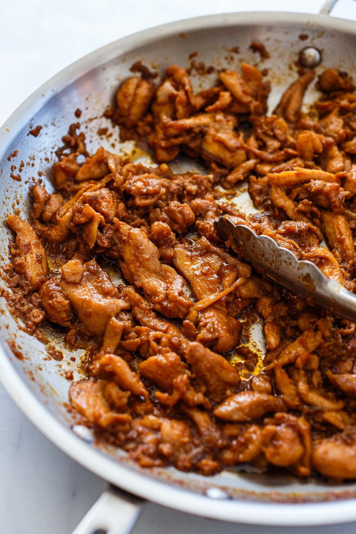 Braising chicken in marinade for Korean Tacos.