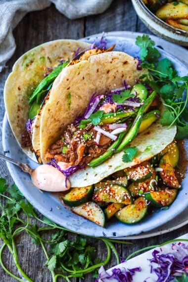 Take taco night to the next level! Korean Tacos with chicken bulgogi are so incredibly flavorful-succulent, marinated chicken is sauteed until tender and topped with fresh avocado, cabbage, and a creamy gochujang taco sauce.