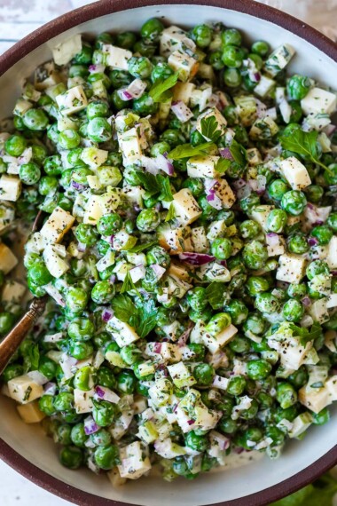 A healthy spruced-up version of classic Pea Salad tossed in a creamy Greek yogurt dressing with lots of fresh herbs and smoked cheddar cheese. Tangy, delicious and all made in one bowl in about 20 minutes! Vegetarian, Vegan adaptable. 