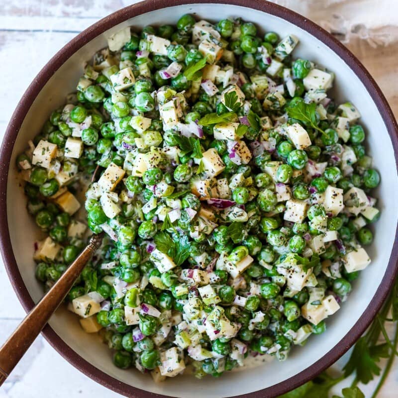 A healthy spruced-up version of classic Pea Salad tossed in a creamy Greek yogurt dressing with lots of fresh herbs and smoked cheddar cheese. Tangy, delicious and all made in one bowl in about 20 minutes! Vegetarian, Vegan adaptable. 