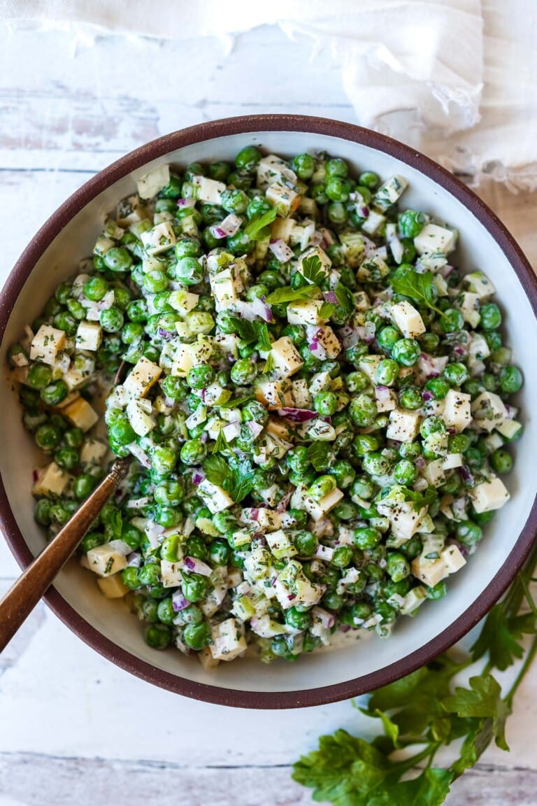 A healthy spruced-up version of classic Pea Salad tossed in a creamy Greek yogurt dressing with lots of fresh herbs and smoked cheese. Tangy, delicious, and made in one bowl in about 20 minutes! Vegetarian, GF, Vegan-adaptable!